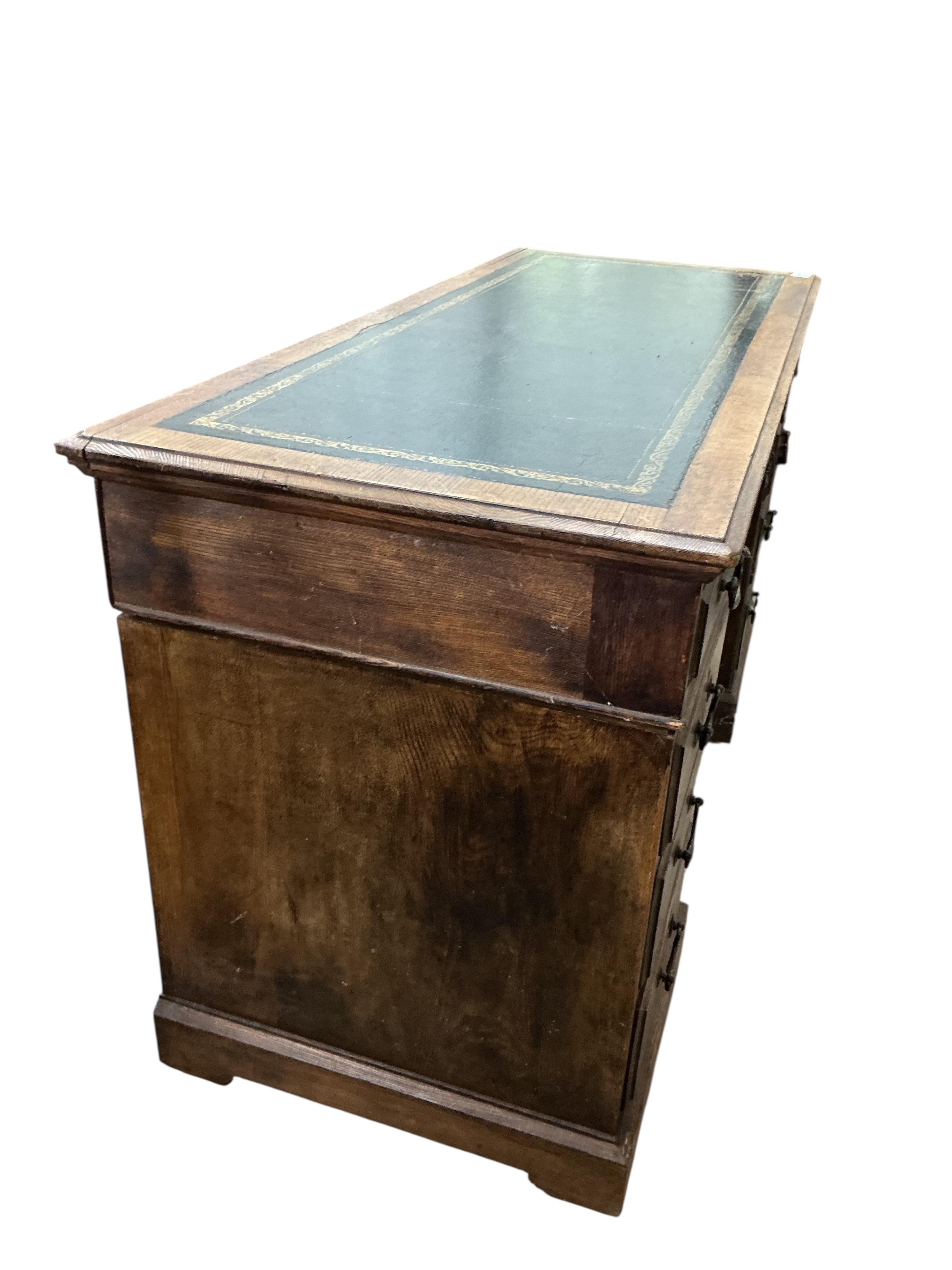 An early 20th century oak pedestal desk, width 138cm, depth 58cm, height 78cm